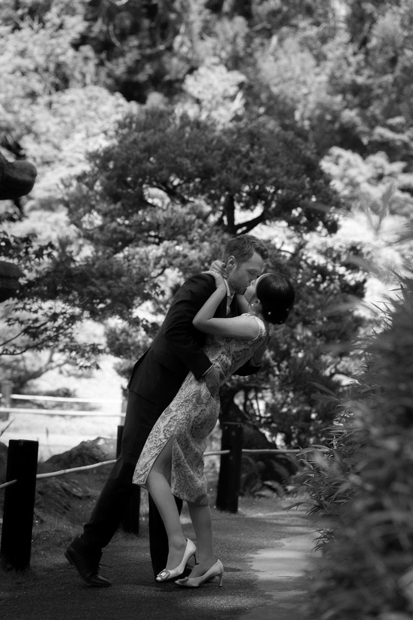 A black-and-white portrait beneath the garden trees