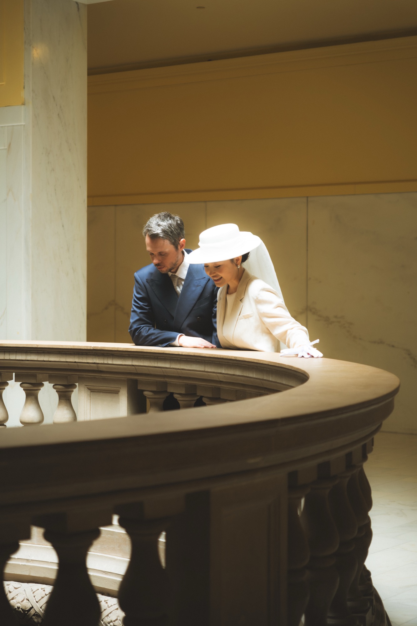 The couple embracing on an upper level of City Hall