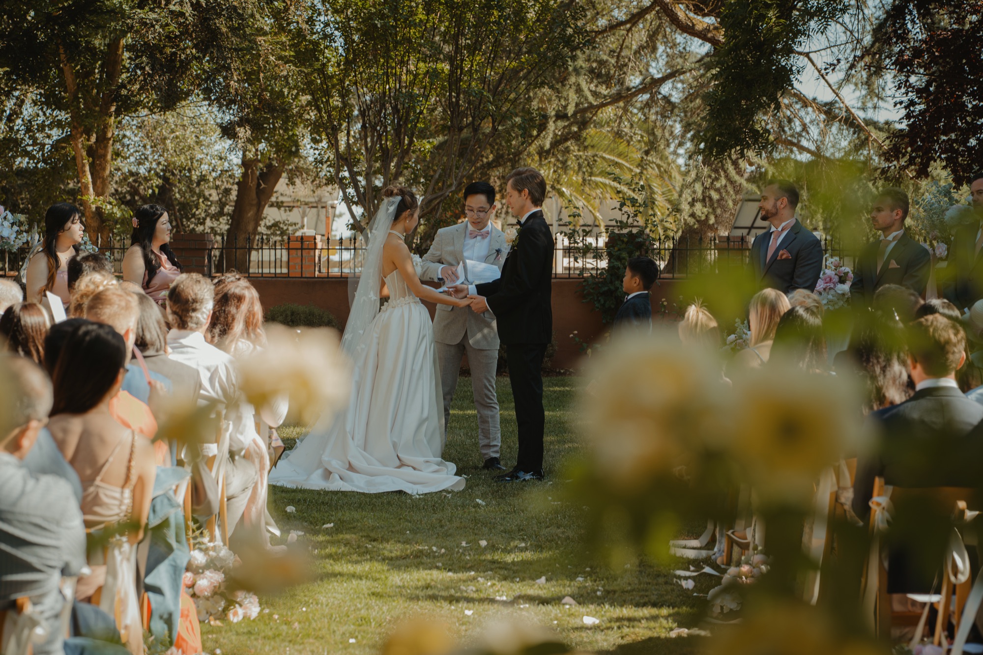The outdoor wedding ceremony beneath the trees