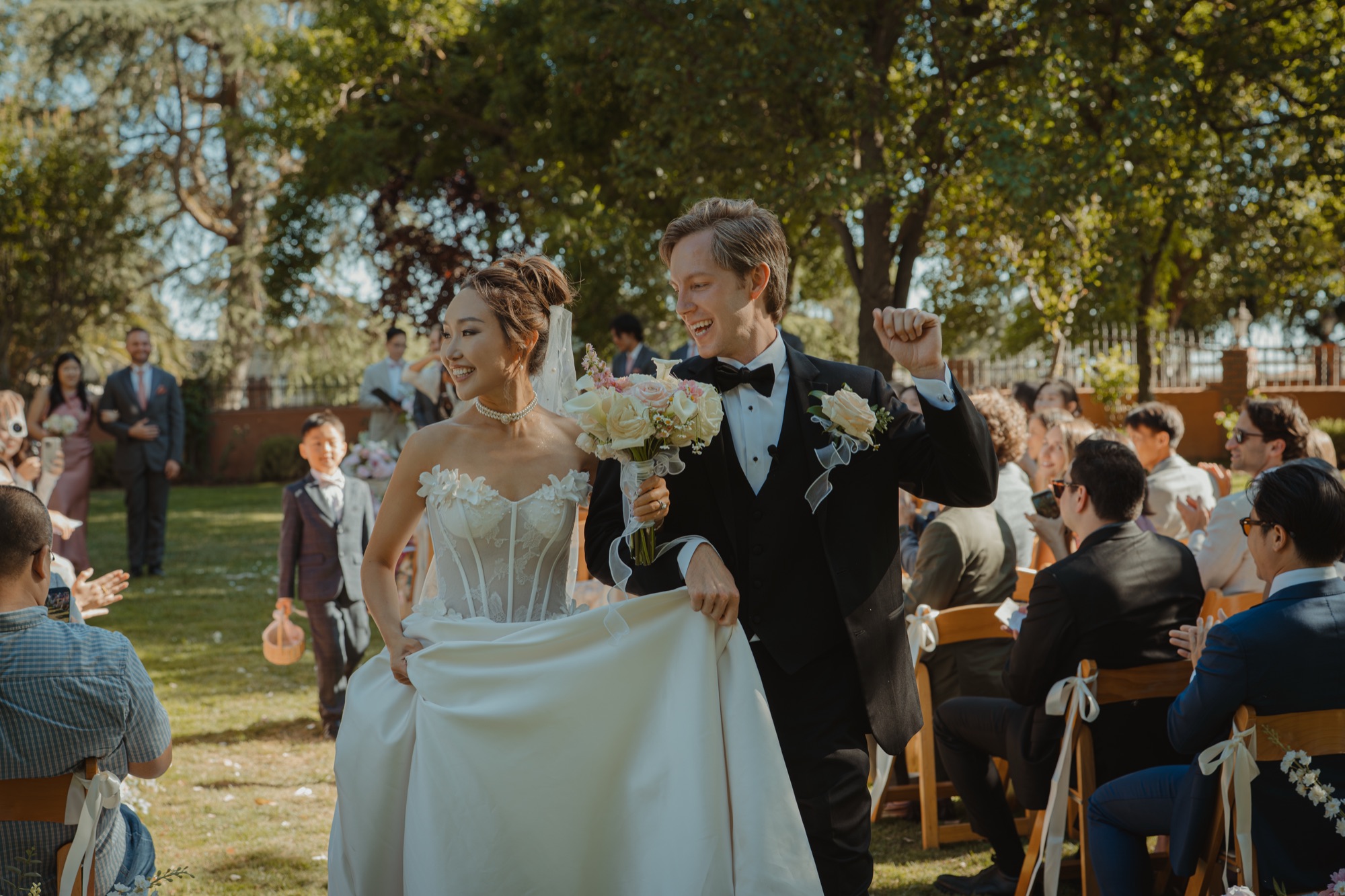 Nicole and Tanner walking back up the aisle together